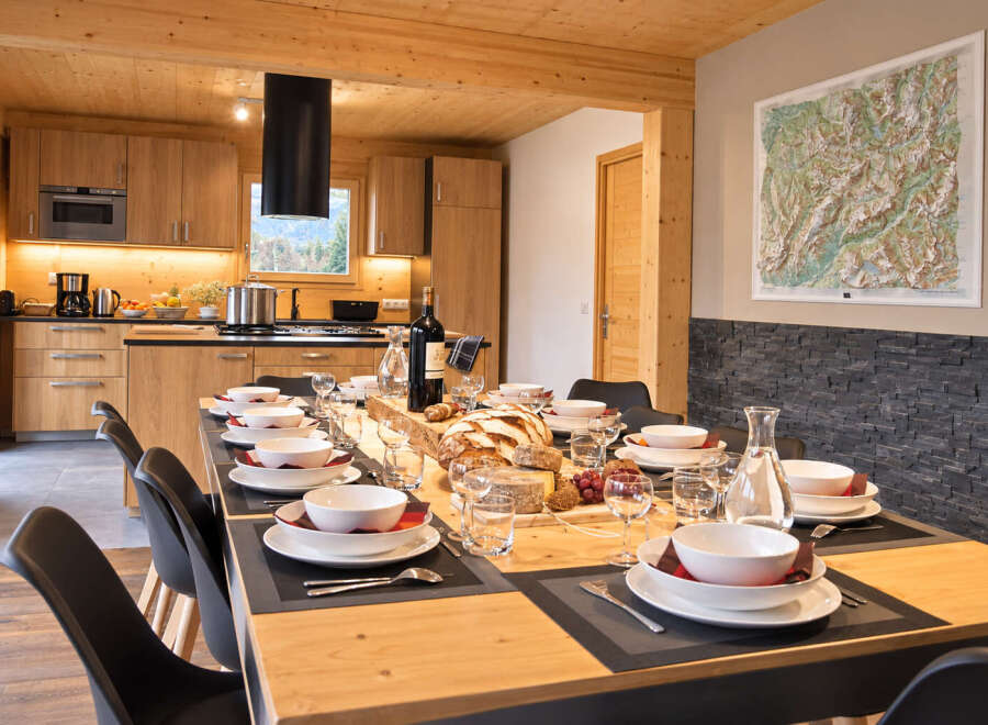 Experience elegant dining in this beautifully appointed space, featuring a long wooden table set for a feast.