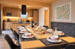 Experience elegant dining in this beautifully appointed space, featuring a long wooden table set for a feast.