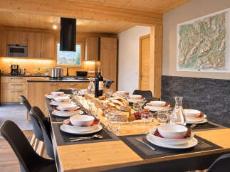 Experience elegant dining in this beautifully appointed space, featuring a long wooden table set for a feast.