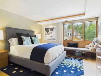 Experience luxurious comfort in this beautifully appointed bedroom, featuring a plush king-sized bed with a sophisticated upholstered headboard.