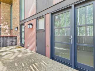 Discover modern living with this inviting entryway featuring a stylish double door and a welcoming doormat.
