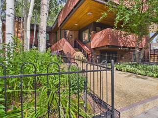 Experience modern living in this stunning home featuring a unique architectural design with warm wood accents and a striking brick exterior.