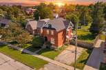 Discover this charming brick home bathed in the warm glow of a sunset.