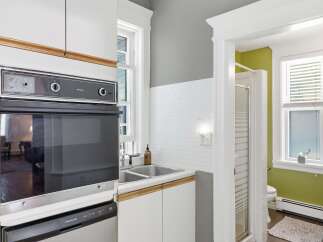 Discover a charming kitchen and bathroom combo, perfect for a compact living space.