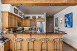 This stunning kitchen features beautiful light wood cabinetry and a spacious granite-topped island, perfect for entertaining.