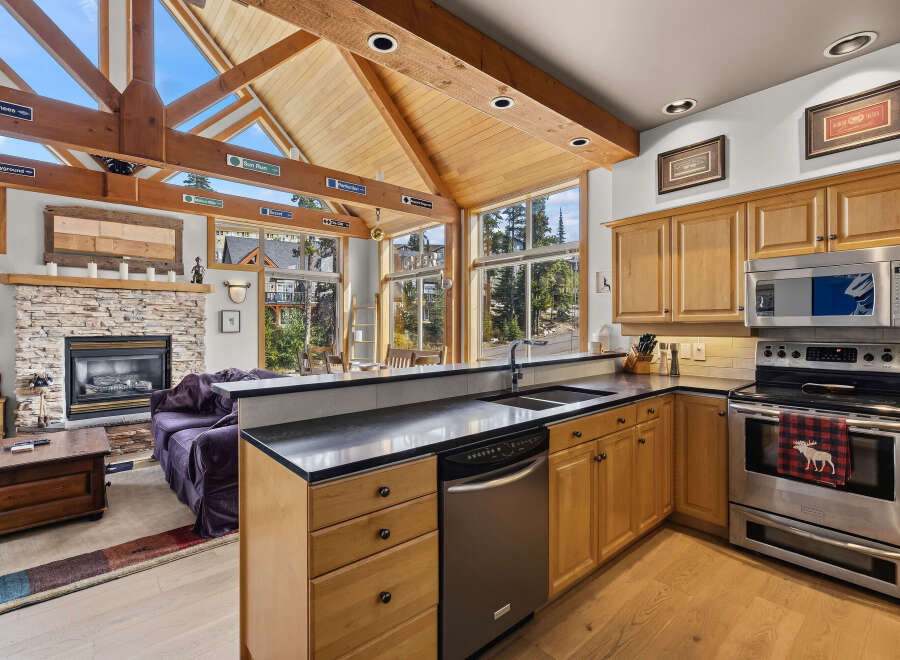 Experience the ultimate mountain retreat in this stunning home featuring a vaulted wood-beamed ceiling and a cozy stone fireplace.