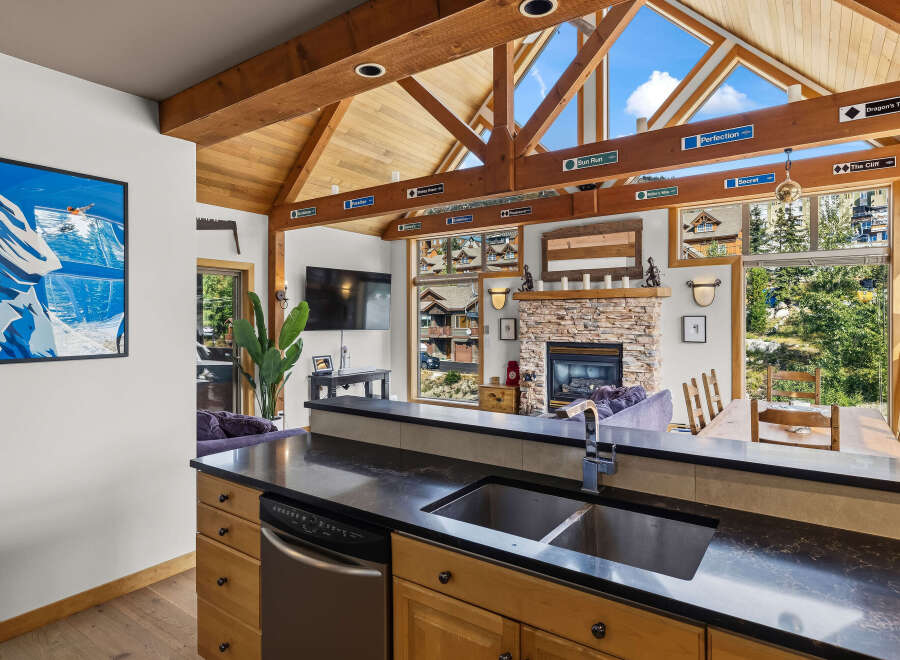 Experience the ultimate mountain retreat with this stunning property, featuring a vaulted wood-beamed ceiling and expansive windows that flood the space with natural light.