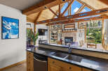 Experience the ultimate mountain retreat with this stunning property, featuring a vaulted wood-beamed ceiling and expansive windows that flood the space with natural light.