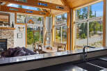 Experience the ultimate mountain retreat in this stunning property featuring a cozy living area with a stone fireplace and a spacious dining area perfect for family gatherings.