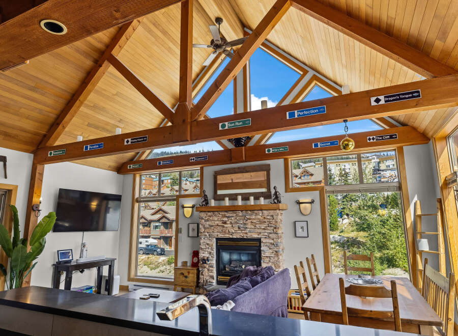 Experience the ultimate mountain retreat in this stunning property featuring a vaulted wood-beamed ceiling and expansive windows offering breathtaking views.