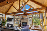 Experience the ultimate mountain retreat in this stunning property featuring a vaulted wood-beamed ceiling and expansive windows offering breathtaking views.