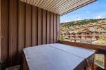 Enjoy breathtaking mountain views from this private balcony, complete with a covered hot tub perfect for year-round relaxation.