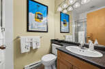 This bathroom features a charming ski-themed poster and decorative towels, adding a unique touch to the space.
