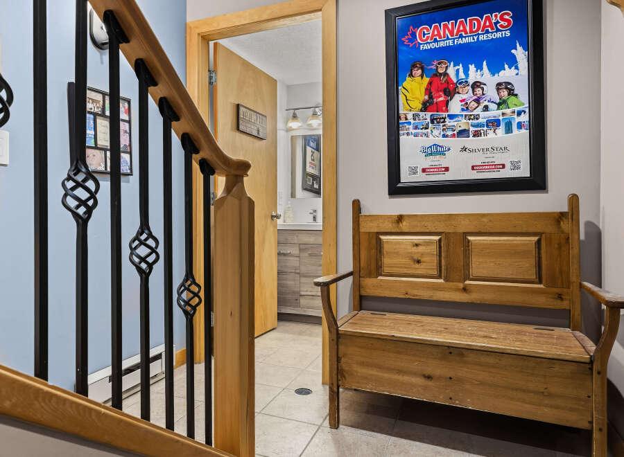 This charming entryway features a wooden bench perfect for removing ski boots after a day on the slopes.