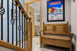 This charming entryway features a wooden bench perfect for removing ski boots after a day on the slopes.