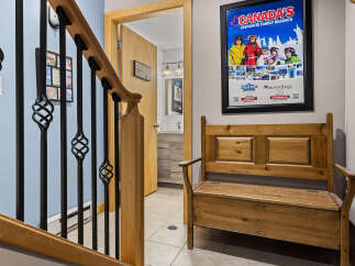 This charming entryway features a wooden bench perfect for removing ski boots after a day on the slopes.