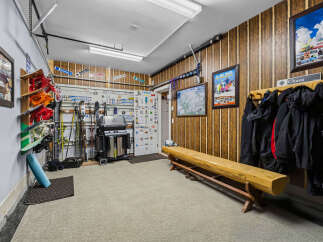 This spacious garage is a ski enthusiast's dream, featuring ample storage for skis, snowboards, and winter gear.