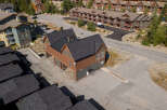 Discover this charming property featuring a unique brown and green multi-story building with a dark shingled roof, offering ample space and character.