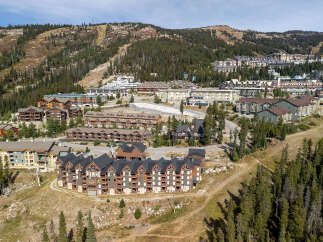 Discover this stunning mountain resort property, featuring a collection of architecturally rich buildings nestled amidst a scenic landscape.