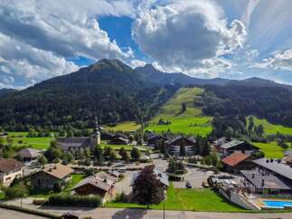 Discover this charming property nestled in a picturesque mountain village, offering breathtaking views of lush green slopes and majestic peaks.