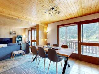 Experience breathtaking mountain views from this charming dining area, featuring a rustic wooden table and comfortable seating.