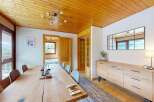 Experience comfortable dining in this charming room featuring a large wooden table and seating for multiple guests.