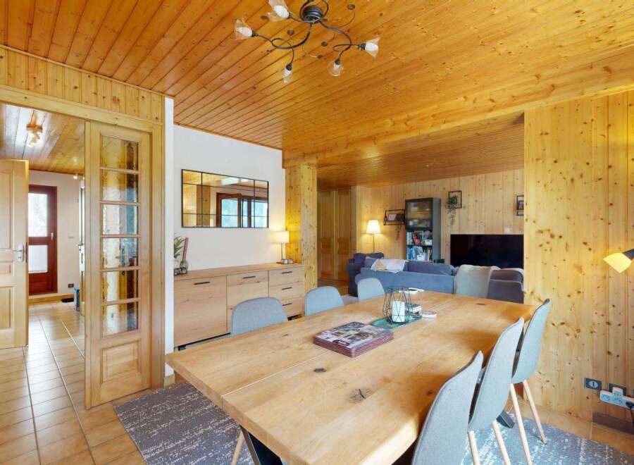 Experience rustic charm in this inviting dining area, featuring a spacious wooden table perfect for gatherings.