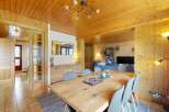 Experience rustic charm in this inviting dining area, featuring a spacious wooden table perfect for gatherings.