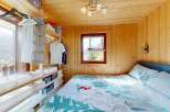 Experience cozy mountain living in this charming bedroom featuring a comfortable bed with nature-themed bedding.