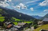 Experience the charm of alpine living in this picturesque village nestled amidst rolling green hills and majestic mountains.