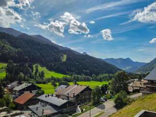 Experience the charm of alpine living in this picturesque village nestled amidst rolling green hills and majestic mountains.