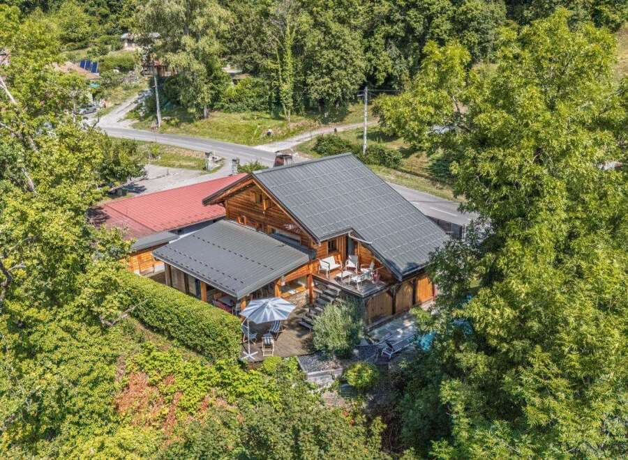 Discover this charming wooden chalet nestled amidst lush greenery, offering a serene mountain retreat.