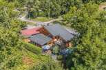 Discover this charming wooden chalet nestled amidst lush greenery, offering a serene mountain retreat.