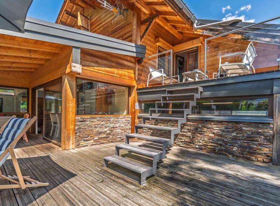 Experience luxury living in this stunning wooden chalet, featuring a spacious multi-level deck perfect for outdoor entertaining.