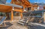 Experience luxury living in this stunning wooden chalet, featuring a spacious multi-level deck perfect for outdoor entertaining.
