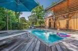 Experience ultimate relaxation in this stunning property featuring a private swimming pool surrounded by a spacious wooden deck.
