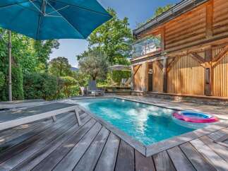 Experience ultimate relaxation in this stunning property featuring a private swimming pool surrounded by a spacious wooden deck.