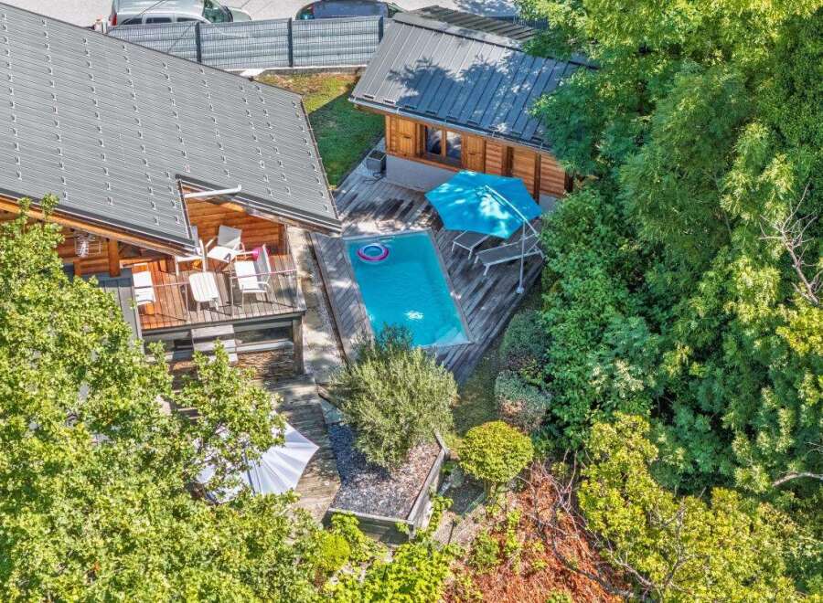 Experience luxury living in this stunning property featuring a private swimming pool surrounded by lush greenery.