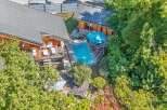 Experience luxury living in this stunning property featuring a private swimming pool surrounded by lush greenery.