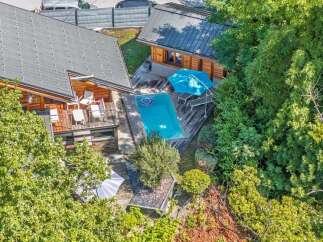 Experience luxury living in this stunning property featuring a private swimming pool surrounded by lush greenery.