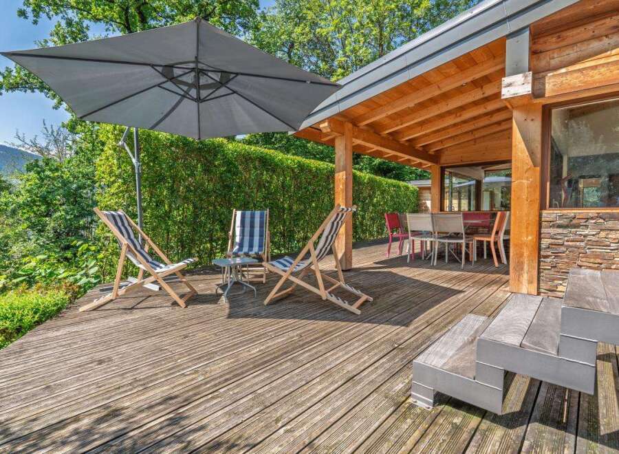 Enjoy the outdoors on this spacious wooden deck, perfect for relaxation and entertaining.