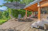 Enjoy the outdoors on this spacious wooden deck, perfect for relaxation and entertaining.