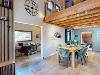 Discover this charming home featuring a dedicated home office space with a desk and printer, perfect for remote work.