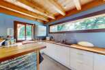 Experience modern living in this stunning kitchen featuring sleek white cabinetry and warm wooden countertops.