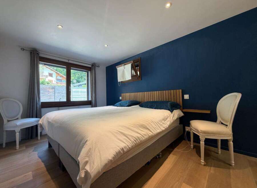 Experience ultimate comfort in this beautifully appointed bedroom, featuring a plush king-size bed dressed in crisp white linens.
