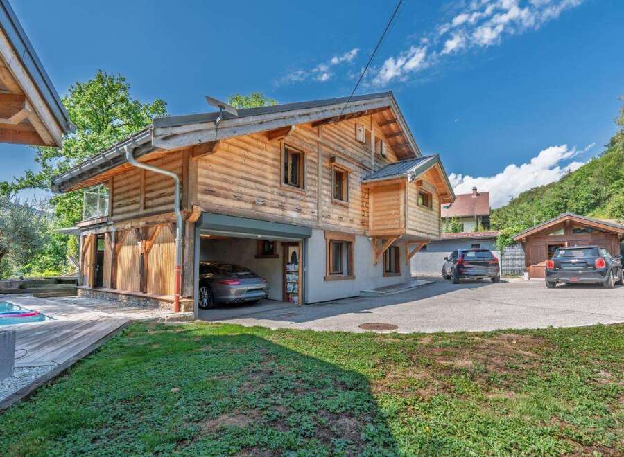 Experience luxury mountain living in this stunning log home, featuring a private swimming pool and a spacious wooden deck perfect for relaxation.