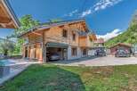 Experience luxury mountain living in this stunning log home, featuring a private swimming pool and a spacious wooden deck perfect for relaxation.