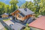 Experience the charm of this rustic wooden chalet nestled amidst lush greenery and mountain views.