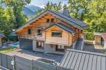 Experience the charm of this stunning wooden chalet, nestled amidst lush greenery with majestic mountain views.