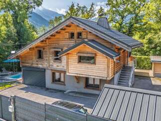 Experience the charm of this stunning wooden chalet, nestled amidst lush greenery with majestic mountain views.
